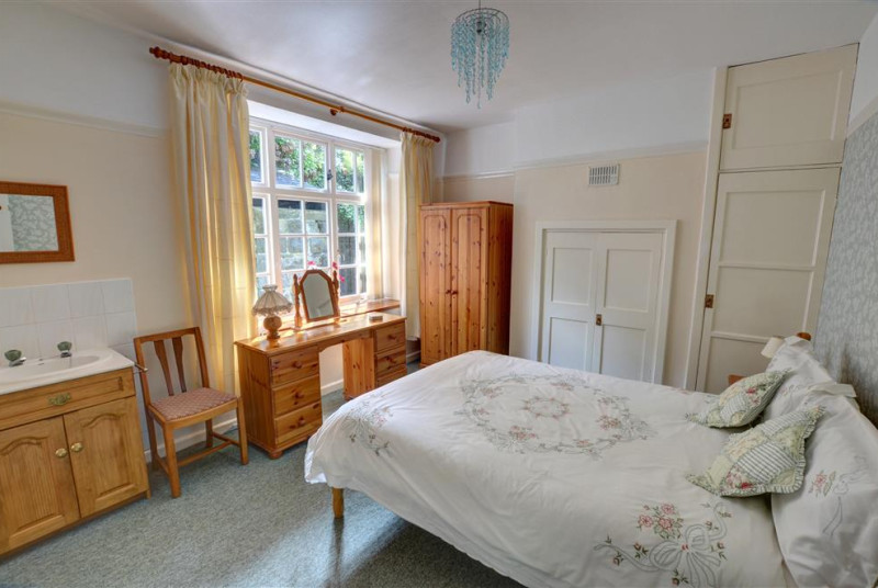 The pretty double bedroom is furnished in pine and is well co-ordinated