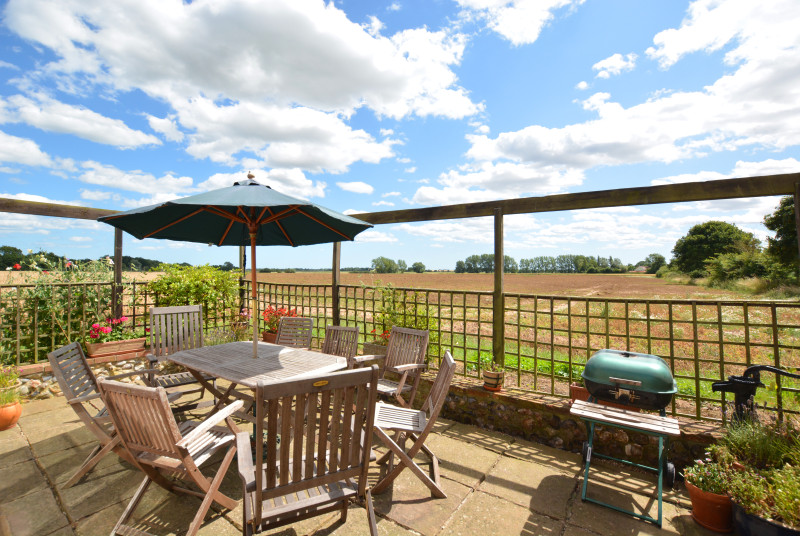 Lovely patio area with comfortable wooden garden furniture, for al fresco dining