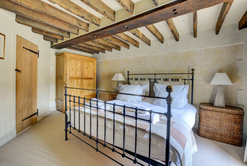 The main bedroom has stunning open beams and bare brick features.