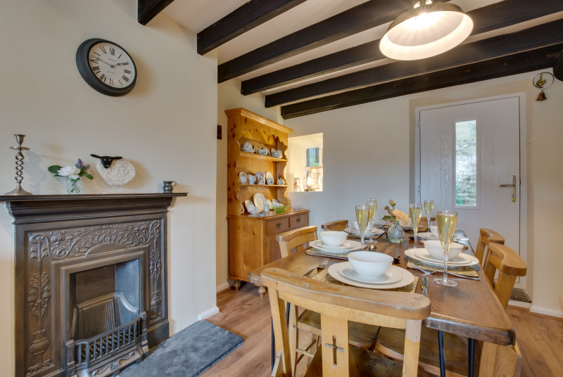 Dining area of the kitchen, with beamed ceiling and victorian fireplace
