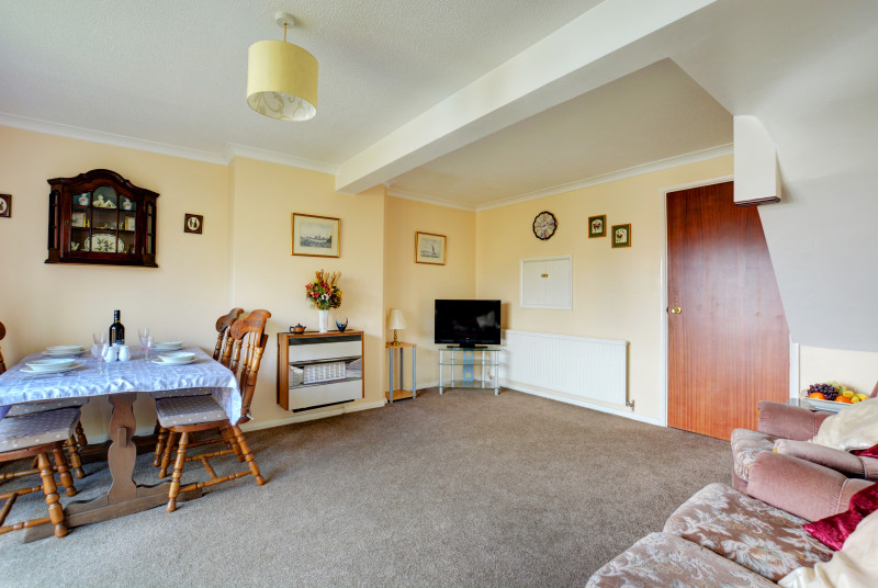 Comfy sofas in a spacious sitting room with a gas fire for cosy evenings