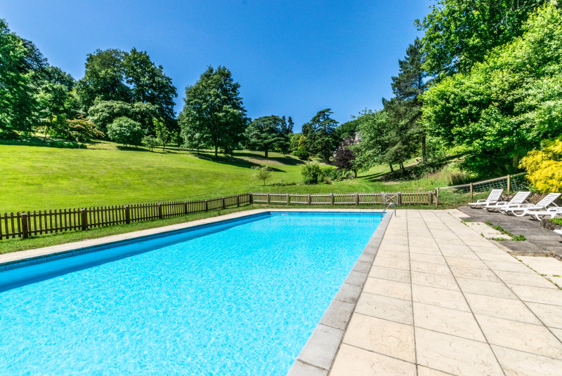 Within the grounds sits an outdoor heated swimming pool