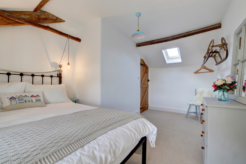 The master bedroom is spacious and decorated in calming colours