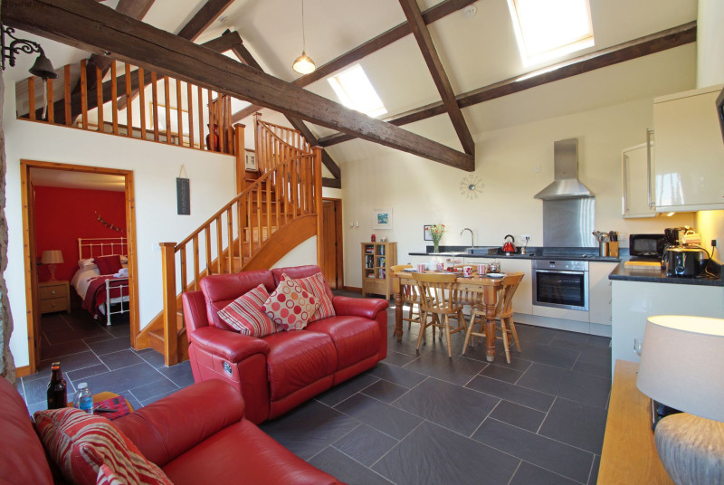 Open plan living area - spacious double height room with beams