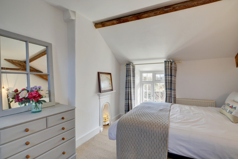 The master bedroom is spacious and decorated in calming colours