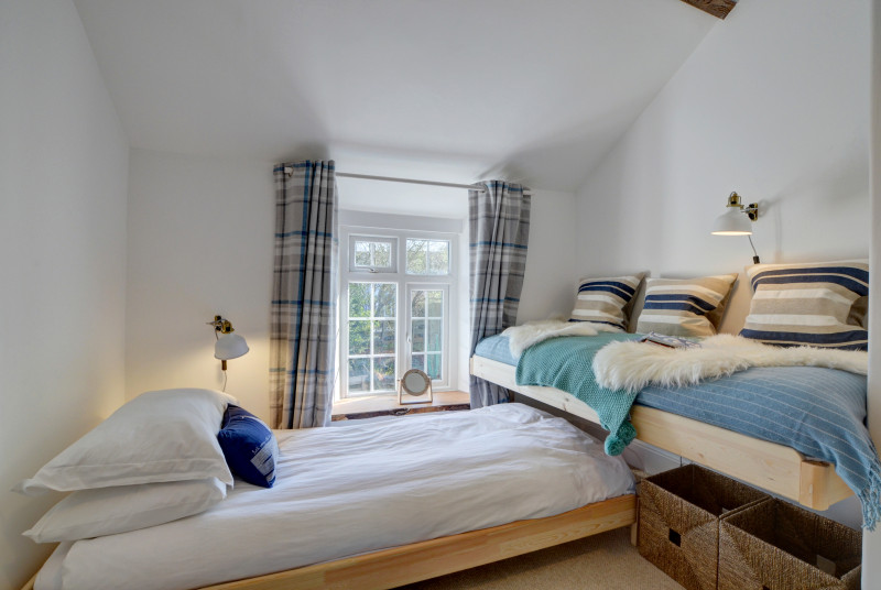 The single bedroom with cosy seating area