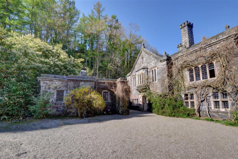 Surrounded by trees and shrubs, the Gatehouse stands to one side of the castle courtyard