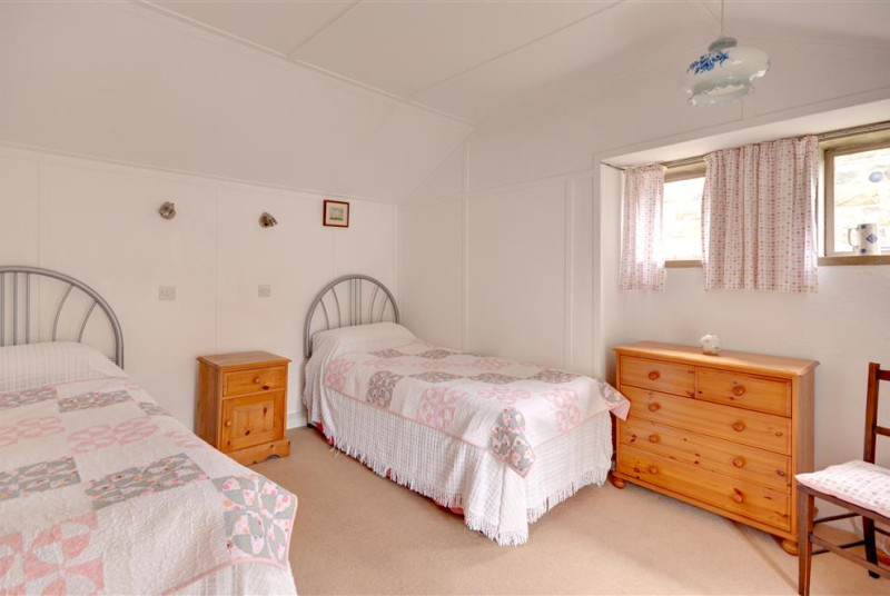 Bedroom 3 has two single beds.