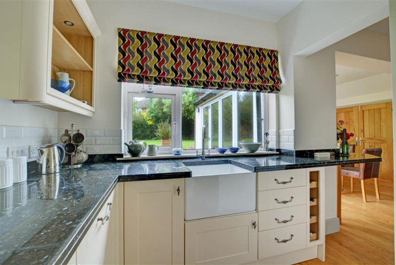 The kitchen has an electric double oven and gas hob