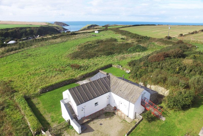 The aerial view with the sea at Abercastle in the background
