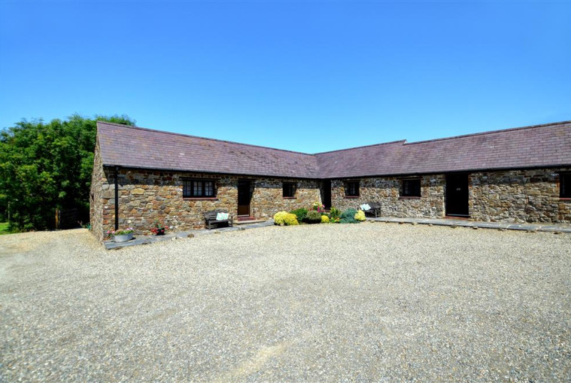 Exterior shot of all the cottages, converted from stone farm buildings