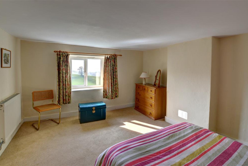 The spacious double bedroom has a lovely view